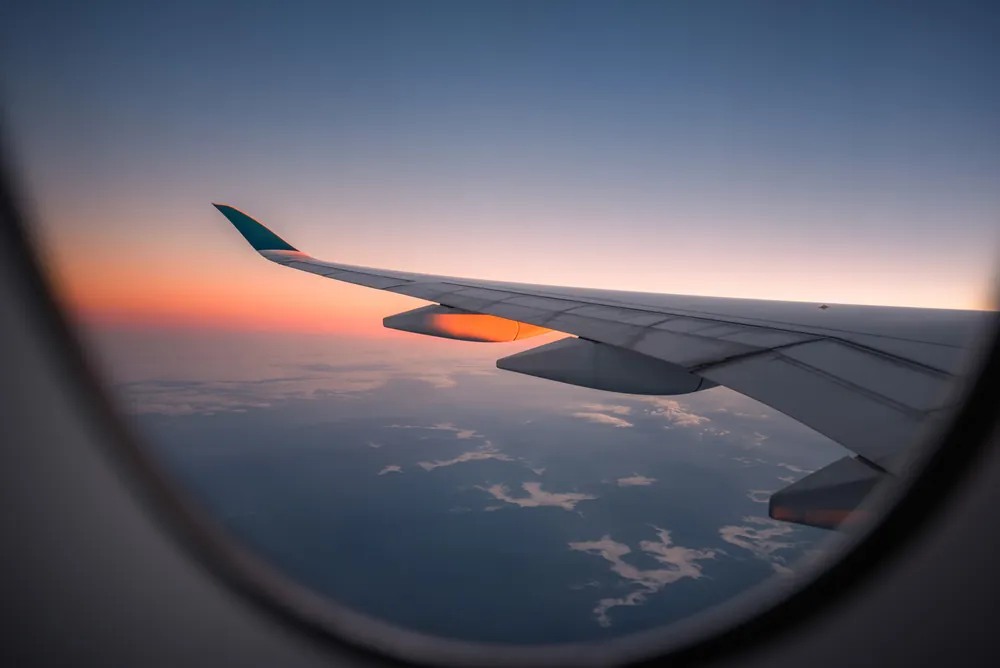 Airplane wing at sunset